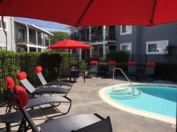 Pool with Furniture and apts buildng Apartments in Oceanside, CA l The Pointe at 2316
